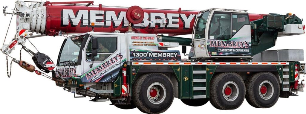 A large mobile crane truck with "Membrey's" branding, red and white boom, and green chassis, featuring multiple wheels and a telescopic arm.